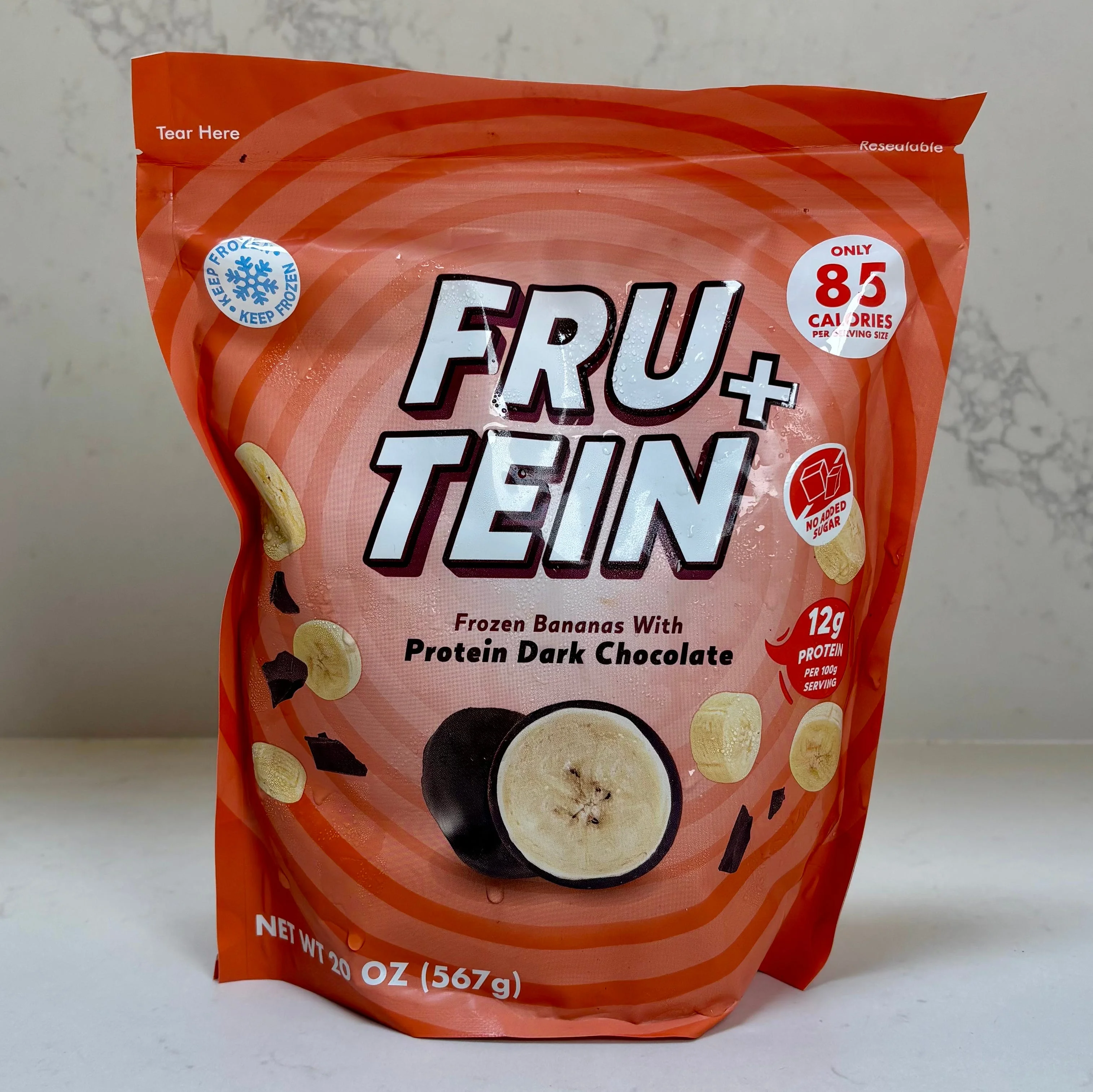 Frozen banana snack in orange packaging.